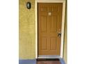 Condo building entry door with a welcome mat at 5275 Images Cir # 306, Kissimmee, FL 34746