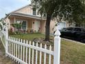 House exterior with picket fence and landscaping at 5453 Wood Crossing St, Orlando, FL 32811