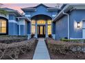 Inviting entryway with a charming walkway leading to a double door entrance at 5590 Whispering Woods Pt, Sanford, FL 32771