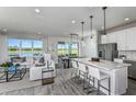 Modern kitchen boasts white cabinets, stainless steel appliances, and an island at 6375 Dew Drop Loop, St Cloud, FL 34771