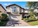 Two-story house with a light-colored facade, brown roof, and manicured landscaping at 8312 Via Rosa, Orlando, FL 32836