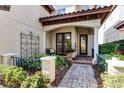 Brick pathway leads to the front entrance with a decorative wrought-iron gate at 8312 Via Rosa, Orlando, FL 32836