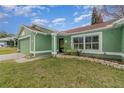 Green house with a landscaped front yard and entryway at 926 Freshmeadow Ct, Apopka, FL 32703