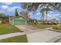 Green house with a driveway and sidewalk at 926 Freshmeadow Ct, Apopka, FL 32703