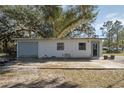 Single story house with attached garage, featuring a grey door and windows at 1016 W Lake Marion Rd, Haines City, FL 33844