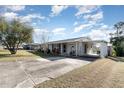 Home's exterior, showcasing a long driveway and carport at 1074 Gerona Ave, Deltona, FL 32725