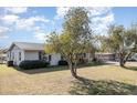 Gray house with mature trees and spacious lawn at 1074 Gerona Ave, Deltona, FL 32725