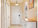 Bright entryway with white door, wood storage, and closet at 1098 Soria Ave, Orlando, FL 32807