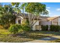 Tan house with brown roof and lush green landscaping at 1098 Soria Ave, Orlando, FL 32807