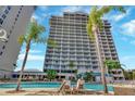 Resort-style pool with lounge chairs and palm trees at 13427 Blue Heron Beach Dr # 1001, Orlando, FL 32821