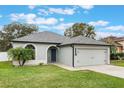 Gray house with a two-car garage and well-manicured lawn at 1698 Riveredge Rd, Oviedo, FL 32766