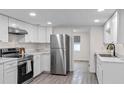 Modern kitchen with stainless steel appliances and white cabinets at 1703 E Fern Rd, Lakeland, FL 33801