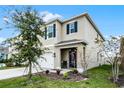 Two-story house with neutral siding, dark shutters, and a charming front entrance at 229 Gina Ln, Davenport, FL 33837