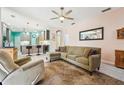 Open living room with a kitchen and island, featuring tile floors at 2647 Aloma Oaks Dr, Oviedo, FL 32765