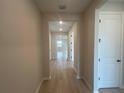 Bright hallway with modern flooring leading to various rooms in the home at 2753 Redblush Ter, St Cloud, FL 34772