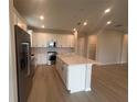 Bright kitchen with stainless steel appliances, a kitchen island, and an open design at 2753 Redblush Ter, St Cloud, FL 34772
