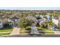 Aerial view of a neighborhood with lake access and solar panels on homes at 2760 Curpin Ln, Orlando, FL 32825