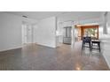 Open living room and kitchen with terrazzo flooring at 3710 Sutton Dr, Orlando, FL 32810