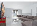 Living room with L-shaped sofa and sliding glass doors at 445 N Andrea Cir, Haines City, FL 33844