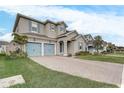 Two-story house with light taupe exterior, blue shutters, and a paved driveway at 4457 Lions Gate Ave, Clermont, FL 34711