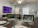 Bright dining area with table set for dinner and view into living room at 5352 Diplomat Ct # 103, Kissimmee, FL 34746