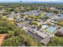 Aerial view of community with pool, tennis court, and townhouses at 549 Sun Ridge Pl # 104, Altamonte Springs, FL 32714