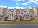 Tan two-story townhouses with brown roofs, stairs, and landscaping at 605 Youngstown Pkwy # 32, Altamonte Springs, FL 32714