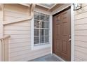 Brown front door with window and white trim at 605 Youngstown Pkwy # 32, Altamonte Springs, FL 32714