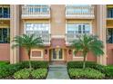 Condo building entrance with palm trees and landscaping at 910 Lotus Vista Dr # 201, Altamonte Springs, FL 32714