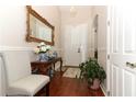 Elegant entryway with hardwood floors and ornate mirror at 962 Canary Lake Ct, Sanford, FL 32773