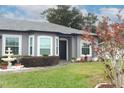 House exterior with a dark brown door and landscaping at 962 Canary Lake Ct, Sanford, FL 32773