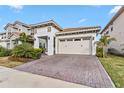Two-story home with a two-car garage and manicured landscaping at 13567 Abberwick Dr, Orlando, FL 32832