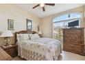 Bedroom with a floral comforter and a wooden dresser at 193 Aurelia Ct, Kissimmee, FL 34758