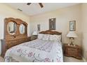 Bedroom with a floral comforter and wooden furniture at 193 Aurelia Ct, Kissimmee, FL 34758