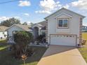 Two story home featuring an attached two car garage and well-maintained landscaping at 193 Aurelia Ct, Kissimmee, FL 34758