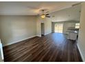 Spacious living room with modern wood-look flooring and a ceiling fan at 238 Locust Rd, Ocala, FL 34472