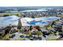 Bird's-eye view of a house near a lake in a residential area at 250 Bayou Bend Rd, Groveland, FL 34736