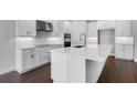 Modern kitchen with a marble top island, modern stainless appliances, and white shaker cabinets at 2987 Arranmore Dr, Ormond Beach, FL 32174