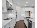 A modern kitchen with white cabinets, stainless appliances, and a large kitchen island at 2987 Arranmore Dr, Ormond Beach, FL 32174