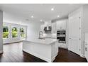 Bright kitchen featuring a large center island, modern appliances, and white cabinetry at 2987 Arranmore Dr, Ormond Beach, FL 32174