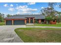 Beautiful orange home with a three-car garage and a large front yard at 3401 Abalone Blvd, Orlando, FL 32833