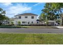 A modern two-story home with clean lines, manicured landscaping, and detached garage at 500 W Hazel St, Orlando, FL 32804