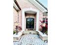 Elegant black double front doors with seasonal decor at 5001 Latrobe Dr, Windermere, FL 34786
