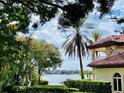 Partial view of a lake from behind a house with palm trees at 5001 Latrobe Dr, Windermere, FL 34786