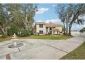 House exterior with fountain and long driveway at 5032 River Lake Rd, Winter Haven, FL 33884