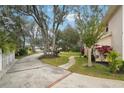 Landscaped yard with a winding pathway and trees at 5032 River Lake Rd, Winter Haven, FL 33884