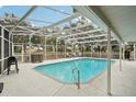 Relaxing screened-in pool area with patio furniture at 5032 River Lake Rd, Winter Haven, FL 33884