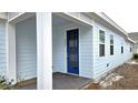 House exterior showcasing a blue front door and porch at 6554 Rover Way, St Cloud, FL 34771