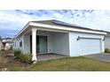 Rear view of house with covered patio and solar panels at 6554 Rover Way, St Cloud, FL 34771