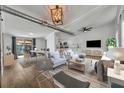 Open-concept living room and dining area with wood-look floors, a modern ceiling, and bright interior at 67 Sabal Cay Court, New Smyrna Beach, FL 32169